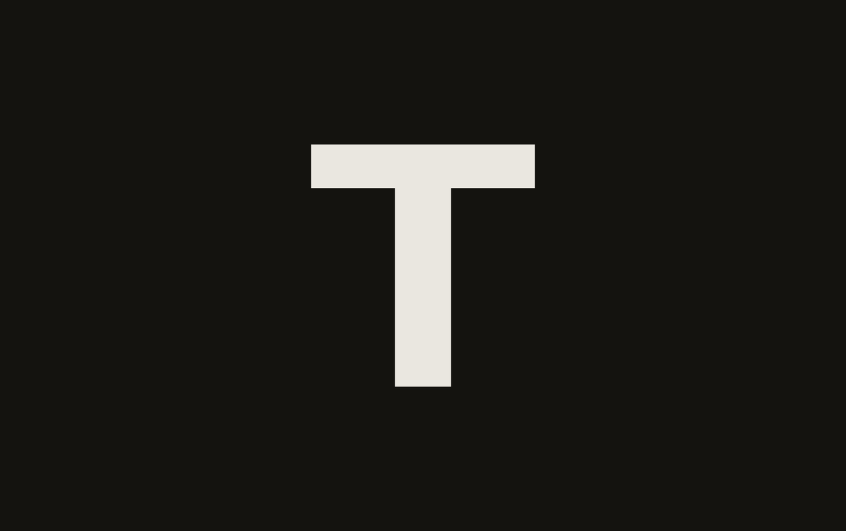 The Taliesin logo, a light capital T on a near-black background.